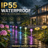Outdoor garden pathway with colorful lights, surrounded by plants and a house in the background, emphasizing waterproof and weather-resistant features.