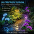 Garden pathway with a waterproof outdoor light surrounded by flowers and rain.