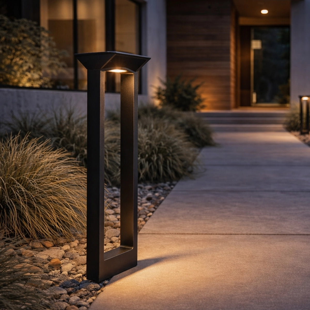 Decorative outdoor lamp post on a pathway leading to a modern house.
